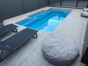 a swimming pool with a bean bag chair and a pillow at Absolutely Beach in Cowes