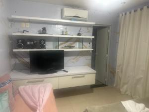 a room with a desk with a tv and speakers at Hotel Pousada Irmaos Freyhardt in Rio de Janeiro