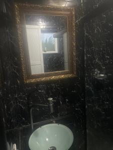 a bathroom with a mirror and a sink at Hotel Pousada Irmaos Freyhardt in Rio de Janeiro