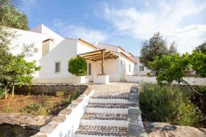 a house with a pathway leading to the front yard at Monte das Oliveiras - Casas de Campo in Estremoz