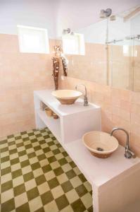 a bathroom with a sink and a glass shower at Monte das Oliveiras - Casas de Campo in Estremoz