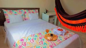 a stuffed teddy bear laying on a bed at Joia do Paraiso - Macapá Luís Correia in Luis Correia +38 photos