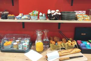 a table with a bunch of different types of food at Hotel Bastille in Paris