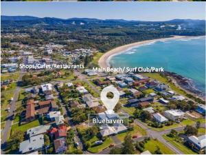 an aerial view of a beach with houses and the ocean at Bluehaven Woolgoolga - Brand New, Ocean Views, 200m Stroll to Beach and Restaurants! in Woolgoolga