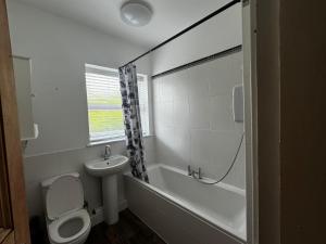 a white bathroom with a toilet and a sink at Single-Bedroom C3 Manchester Close To Bolton Centre in Little Hulton