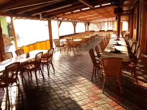 a row of tables and chairs in a restaurant at Pension u Vlčků in Hracholusky