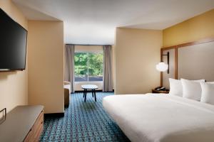 a hotel room with a bed and a television at Fairfield Inn by Marriott Lexington Park Patuxent River Naval Air Station in Lexington Park +56 photos