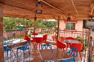a patio with tables and chairs on a balcony at Amazing Grace Hotel & Suites in Accra
