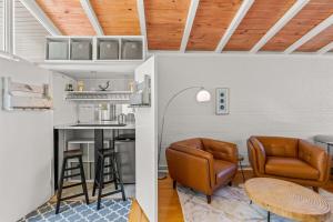 a kitchen and living room with leather chairs and a table at Modern Retreat Hot Tub Bar Patio HPU in High Point