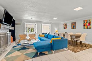 a living room with a blue couch and a table at Modern Retreat Hot Tub Bar Patio HPU in High Point +38 photos