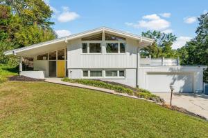a white house with a lawn in front of it at Upscale Modern Home with perfect triad location in High Point