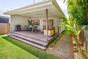 a house with a wooden deck in the backyard at Moffat Beach Entertainer with Kids Retreat & Walk to Beach in Caloundra