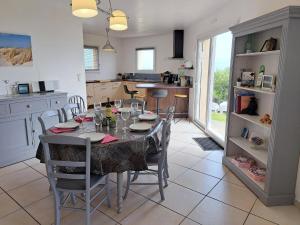 a dining room with a table and chairs in a kitchen at Villa in Crozon with Sea Views & Sandy Beach in Telgruc-sur-Mer