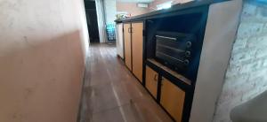 a kitchen with a black stove and wooden cabinets at Casa Quinta Nuevo Torino -15 min de Rafaela in Nuevo Torino