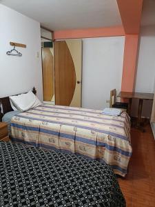 Rúm í herbergi á Hostal Ayllu