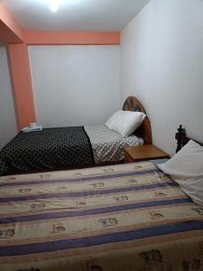Rúm í herbergi á Hostal Ayllu