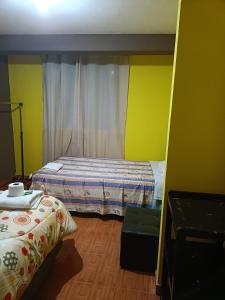 Rúm í herbergi á Hostal Ayllu