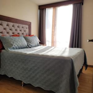 a bedroom with a bed with a large window at Elegante apartamento cerca de Embajada de los EEUU y Cayala in Guatemala +38 photos