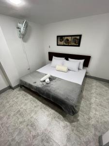 a bedroom with a bed with two towels on it at Hotel Armenia Lions in Armenia