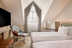 Postel nebo postele na pokoji v ubytování Courtyard by Marriott Magdeburg + 21 fotografií