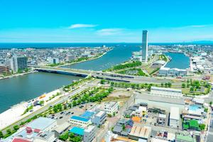 an aerial view of a city and a river at Hotel Sunroute Niigata in Niigata
