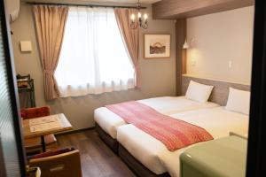 Postel nebo postele na pokoji v ubytování 7 Rooms Hotel & Cafe - デザイナーズホテル - 30mins from Disneyland