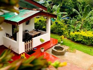 an aerial view of a small house with a roof at Ella Willow Cottage in Ella