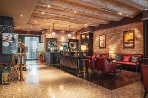 a lobby with a bar and a brick wall at Alagon D'antique Boutique Hotel & Spa in Ho Chi Minh City
