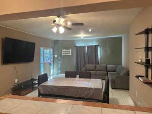 a living room with a bed and a couch at Casa Guadalupe Victoria in Matamoros