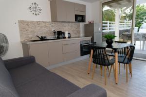 a kitchen and living room with a table and chairs at LA DESIRADE SAINTE-ANNE in Sainte-Anne