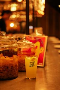 a table with jars of food and a drink at NOHGA HOTEL AKIHABARA TOKYO in Tokyo