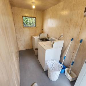 a small kitchen with a washing machine and a sink at 16 Northgate Motor Lodge in New Plymouth +22 photos