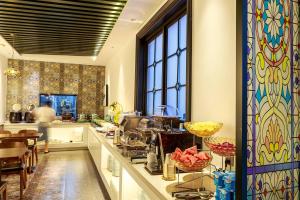 a kitchen with a long counter with a counter top at Nost algia S Hotel Near Chengdu Kuanzhai Alley - People's Park, Chengdu Panda Base, 10 minutes walk to subway , Free laundry, English communication well, Free coffee,Free travel advice in Chengdu