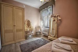 a bedroom with a bed and a dresser and a mirror at QUEEN MARIA Apartments in Demir Kapija