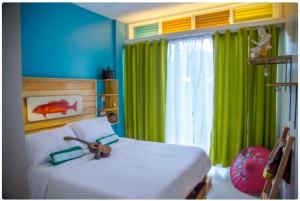 A bed or beds in a room at Flotsam and Jetsam Artist Beach Hostel