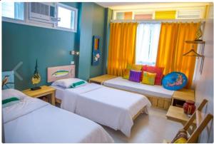 A bed or beds in a room at Flotsam and Jetsam Artist Beach Hostel