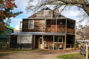 an old house with a balcony on top of it at Snug as a Bug Omeo in Omeo