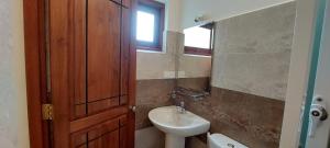 a bathroom with a sink and a toilet and a mirror at Windy Ridge Kandy in Kandy +153 photos