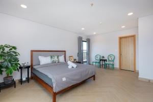 une chambre avec un grand lit et deux chaises dans l'établissement ARIA Vũng Tàu - Thành Phố Vũng Tàu, à Xã Thắng Nhứt 16 autres photos