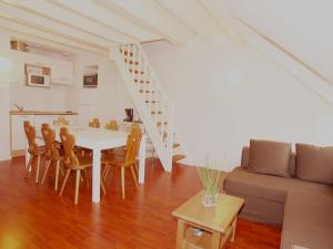 a living room with a table and chairs and a couch at Résidence Vignec Village by Actisource in Vignec