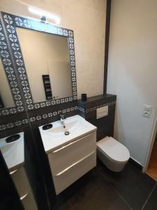 a bathroom with a sink and a toilet and a mirror at Mon Paris in Neuilly-sur-Seine +26 photos