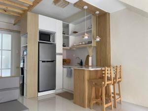 a kitchen with a counter with a refrigerator and a stove at Casa Theresa in Butuan