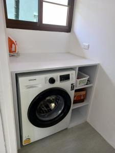 a washing machine in a laundry room with a window at Villa Paradise Island in Rawai Beach