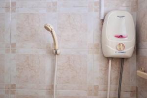 a shower in a bathroom with a shower head at Airport View Apartment Cozy room near Airport in Samutprakarn +5 photos
