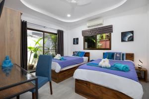 a bedroom with two beds and a desk and a window at Villa Paradise Island in Rawai Beach +34 photos