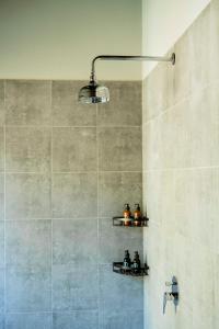 a bathroom with a shower with a shower head and a light at The Spice Trail in Arugam Bay