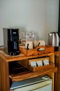a wooden counter top with a coffee maker and appliances at The Spice Trail in Arugam Bay