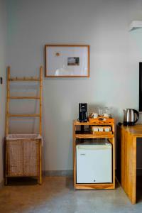 a kitchen with a counter and a shelf and a ladder at The Spice Trail in Arugam Bay
