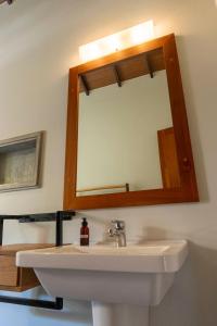a bathroom with a sink and a mirror at The Spice Trail in Arugam Bay