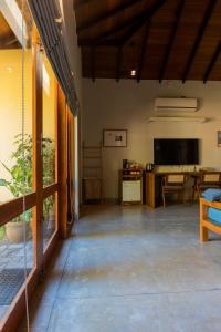 a living room with a television and a table at The Spice Trail in Arugam Bay